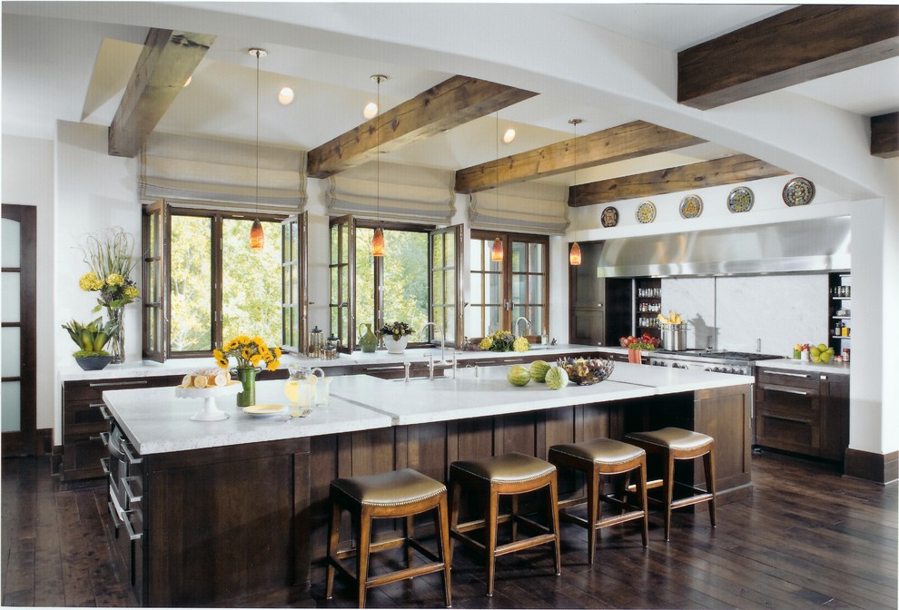 Large transitional l-shaped eat-in kitchen in Chicago with dark wood cabinets, white splashback, stainless steel appliances, dark hardwood floors, with island, shaker cabinets and brown floor.