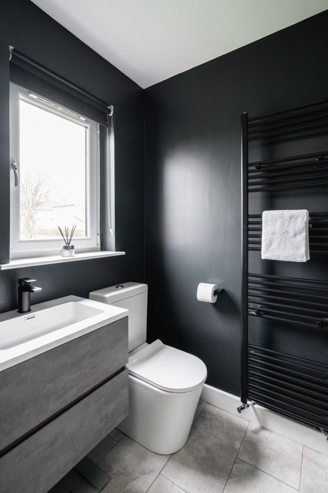 This is an example of a contemporary bathroom in Glasgow with flat-panel cabinets, grey cabinets, black walls, an integrated sink, grey floor, white benchtops, a single vanity and a floating vanity.