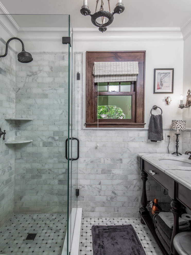 This is an example of a small country 3/4 bathroom in Other with open cabinets, black cabinets, a corner shower, white tile, marble, white walls, ceramic floors, an undermount sink, marble benchtops, white floor, a hinged shower door and white benchtops.