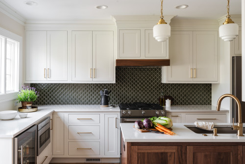 White shaker kitchen cabinets with a dark geometric tile backsplash and walnut island for a modern classic look