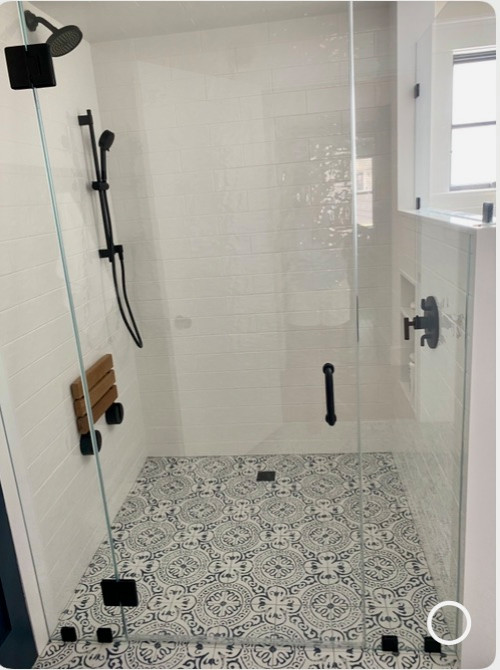 Photo of a traditional bathroom in Boston with beaded cabinets, blue cabinets, a walk-in shower, a one-piece toilet, ceramic tiles, white walls, ceramic flooring, a submerged sink, marble worktops, blue floors, a hinged door, white worktops, a single sink and a freestanding vanity unit.