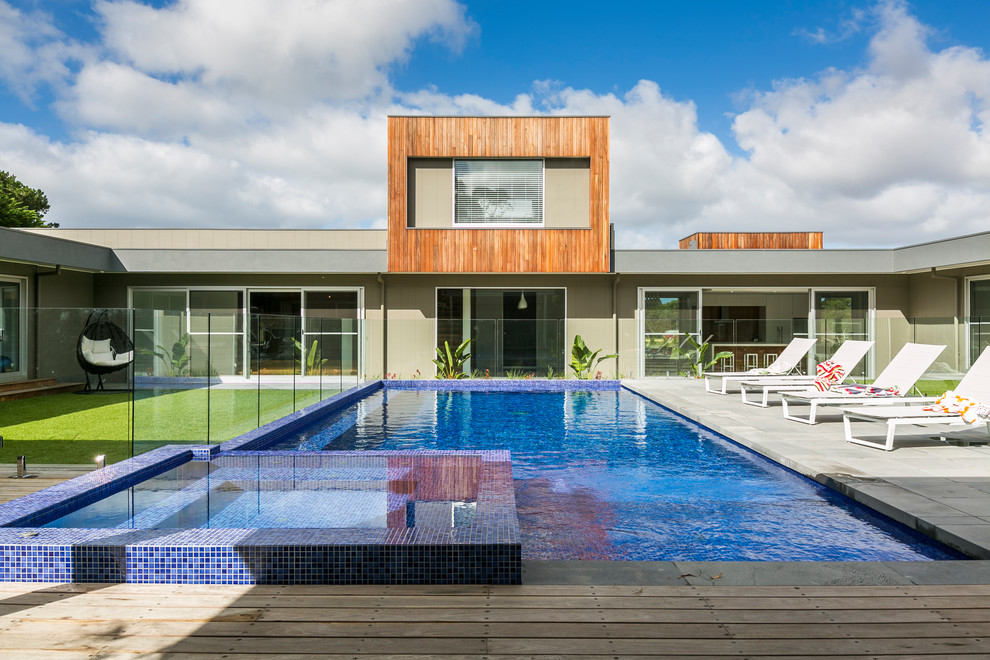 Expansive contemporary courtyard rectangular lap pool in Geelong with a hot tub and concrete pavers.