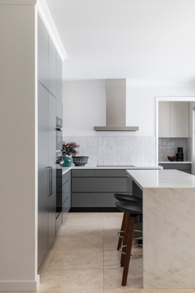 Inspiration for a mid-sized contemporary l-shaped kitchen in Sydney with flat-panel cabinets, grey cabinets, grey splashback, panelled appliances, porcelain floors, with island and beige floor.