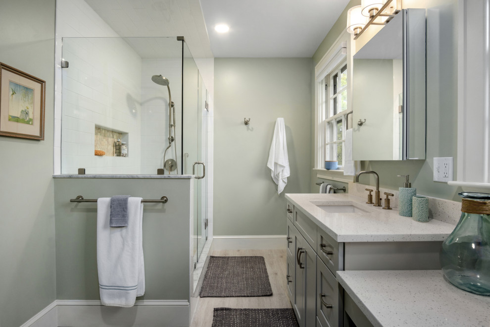 Example of a mid-sized transitional 3/4 white tile and porcelain tile vinyl floor, beige floor and single-sink corner shower design in Providence with shaker cabinets, gray cabinets, a one-piece toilet, green walls, an undermount sink, quartz countertops, a hinged shower door, multicolored countertops, a niche and a built-in vanity