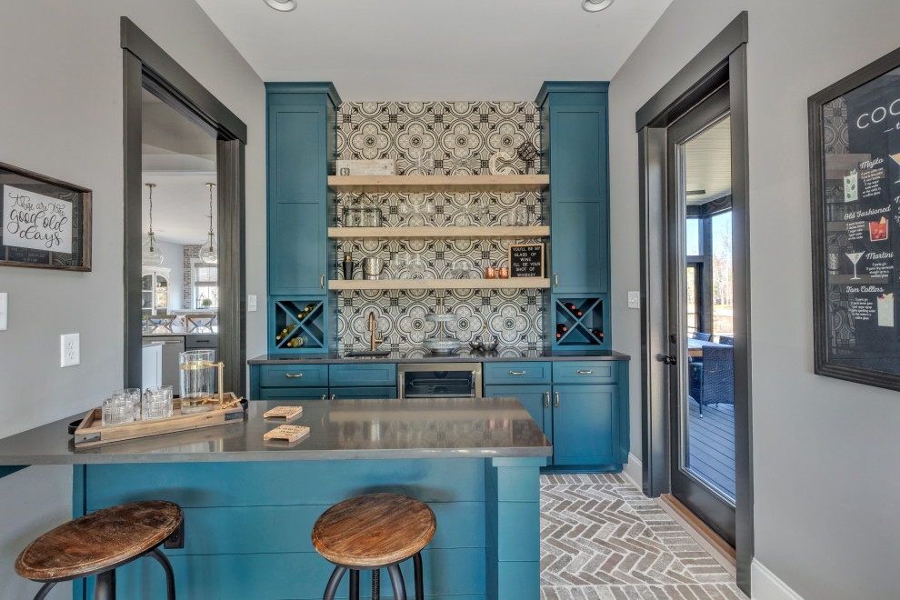 Photo of a country galley seated home bar in Richmond with an undermount sink, shaker cabinets, blue cabinets, grey splashback, brick floors, grey floor and grey benchtop.