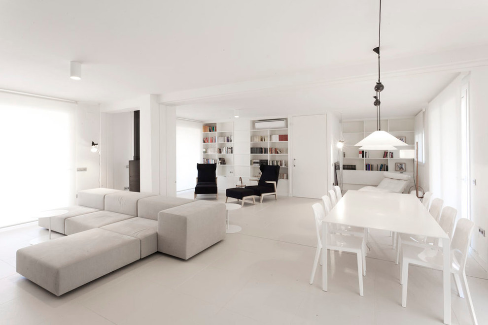 This is an example of a large modern separate dining room in Barcelona with white walls.