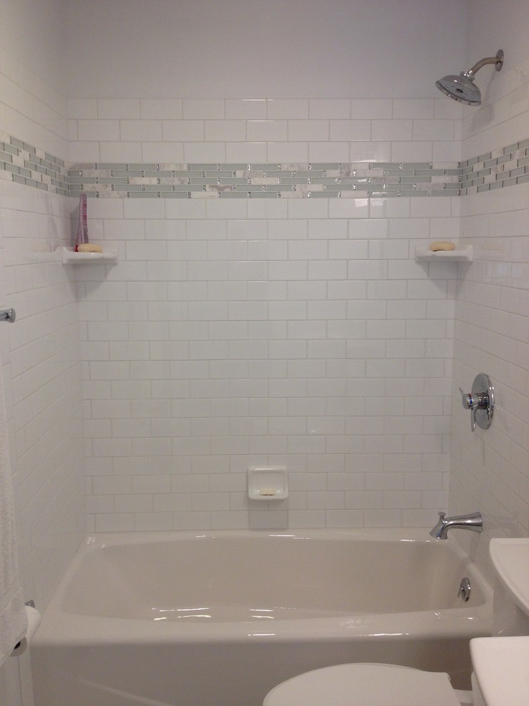 Photo of a small transitional master bathroom in Other with an alcove tub, a shower/bathtub combo, a two-piece toilet, white tile, porcelain tile, white walls, porcelain floors and a pedestal sink.
