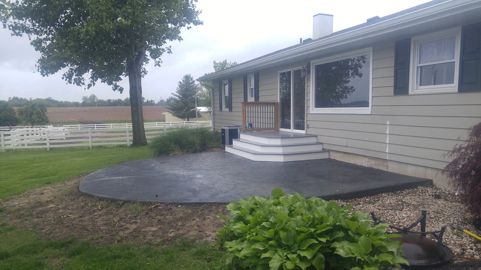 Inspiration for an expansive country side yard patio in St Louis with stamped concrete.