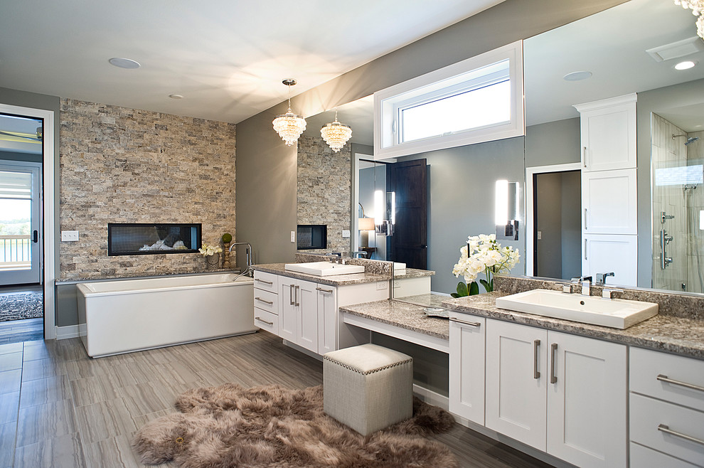 Inspiration for an expansive eclectic master bathroom in Other with raised-panel cabinets, white cabinets, a freestanding tub, an alcove shower, mirror tile, grey walls, porcelain floors, a vessel sink, granite benchtops, multi-coloured floor and a hinged shower door.