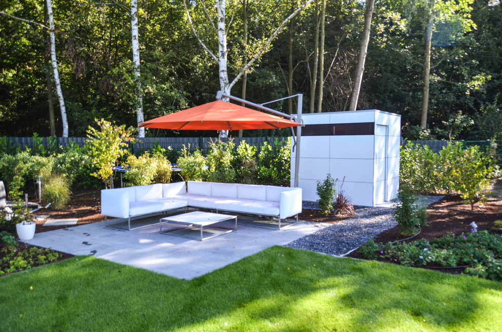 Photo of a mid-sized contemporary backyard deck in Dusseldorf with an awning.