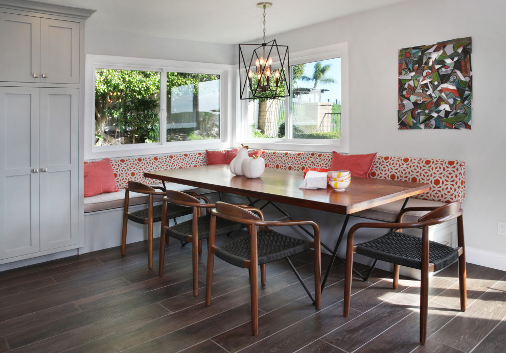 This is an example of a large transitional kitchen/dining combo in Orange County with grey walls and brown floor.