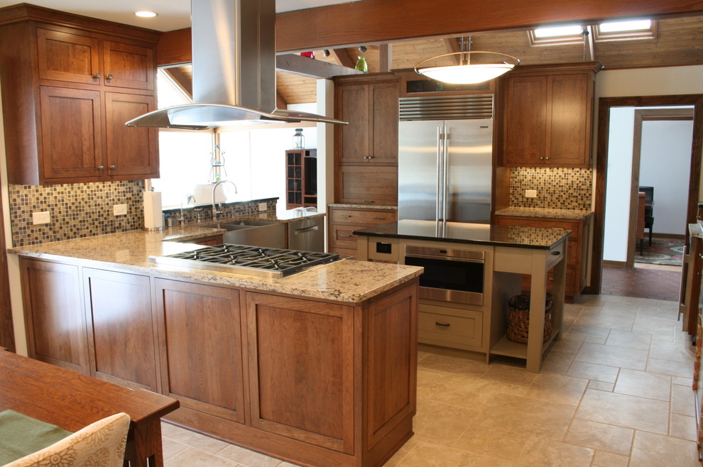Example of a large transitional u-shaped ceramic tile eat-in kitchen design in Chicago with a farmhouse sink, shaker cabinets, medium tone wood cabinets, granite countertops, multicolored backsplash, mosaic tile backsplash, stainless steel appliances and an island