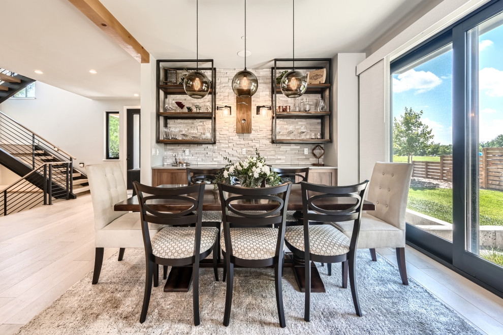 Photo of a medium sized contemporary open plan dining room in Denver with beige walls, laminate floors, brown floors and exposed beams.