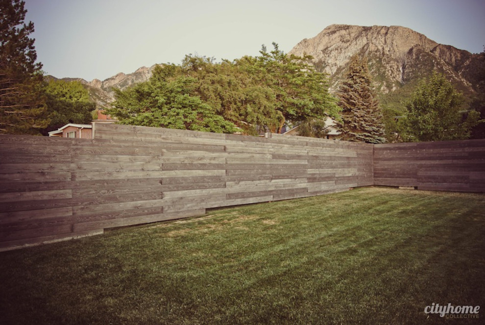 This is an example of a large contemporary backyard full sun garden in Salt Lake City with mulch.