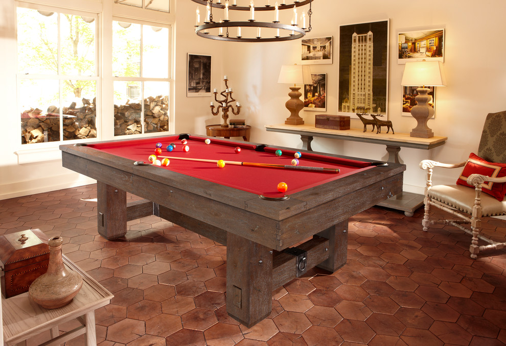 This is an example of a mid-sized country enclosed family room in Orange County with a game room, beige walls, terra-cotta floors, no fireplace and no tv.