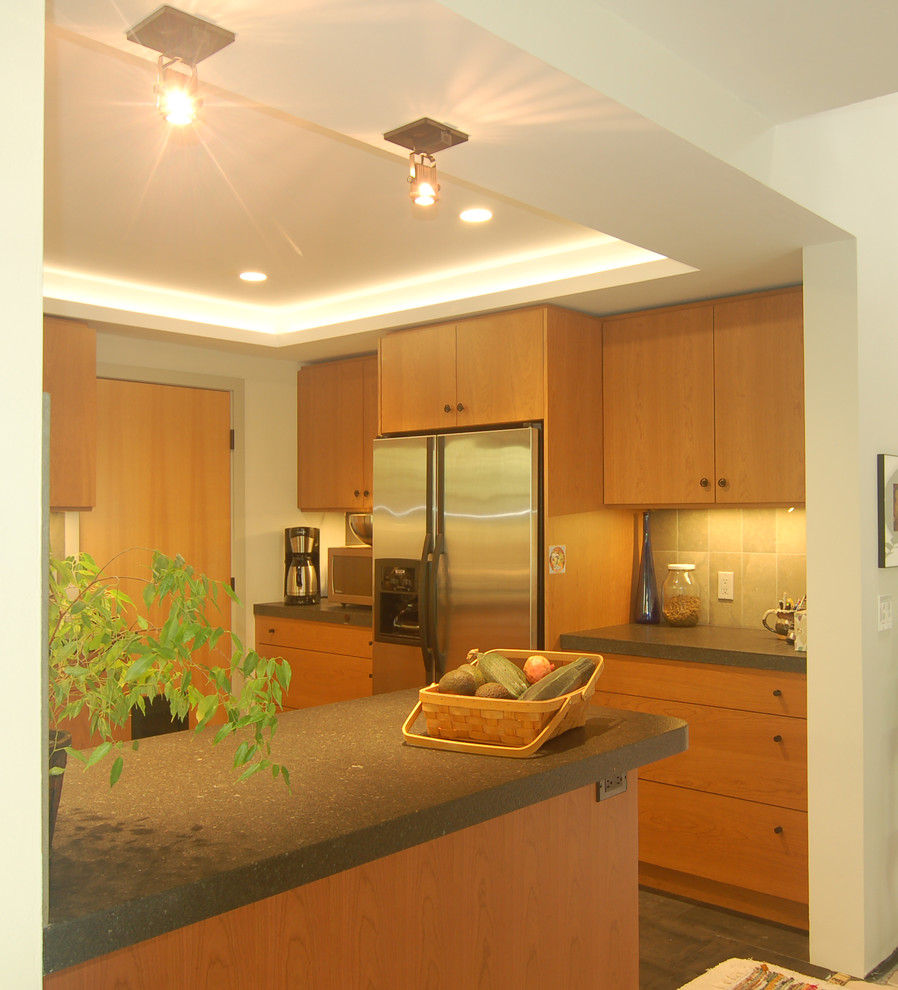 This is an example of a small modern u-shaped separate kitchen in San Luis Obispo with an undermount sink, flat-panel cabinets, light wood cabinets, quartz benchtops, green splashback, porcelain splashback, stainless steel appliances, slate floors and a peninsula.