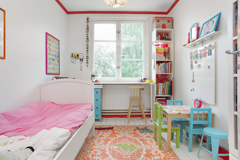 Inspiration for a mid-sized eclectic gender-neutral kids' bedroom for kids 4-10 years old in Stockholm with white walls and painted wood floors.