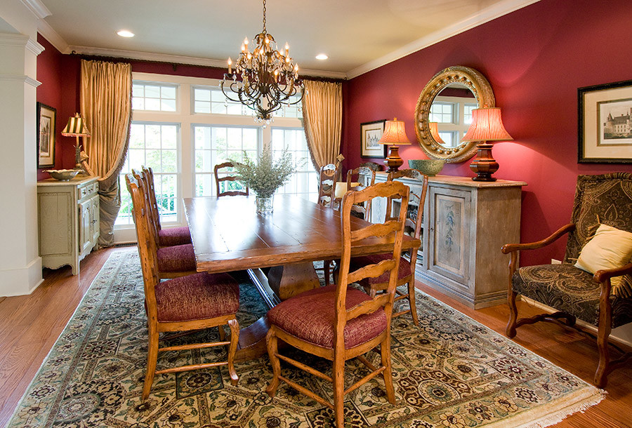 Large traditional separate dining room in Orlando with red walls, medium hardwood floors, no fireplace and brown floor.