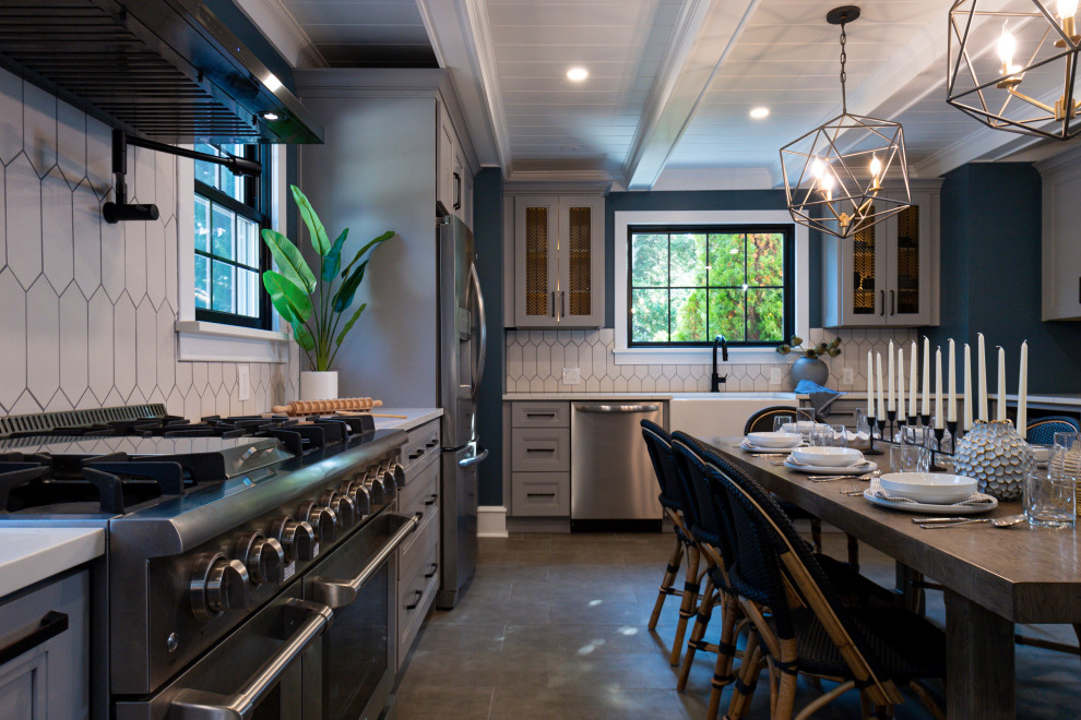 This is an example of a large transitional l-shaped eat-in kitchen in Philadelphia with a farmhouse sink, white cabinets, white splashback, grey floor, white benchtop, exposed beam, shaker cabinets, quartz benchtops and ceramic splashback.