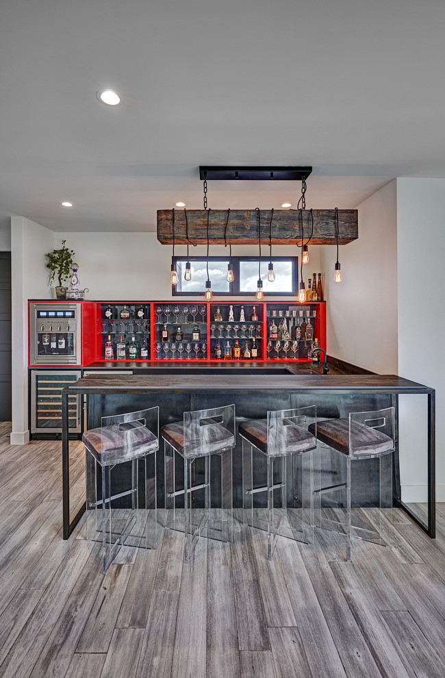 Design ideas for a large industrial u-shaped seated home bar in Sacramento with an undermount sink, quartz benchtops, grey splashback, grey floor, grey benchtop, open cabinets, red cabinets and medium hardwood floors.