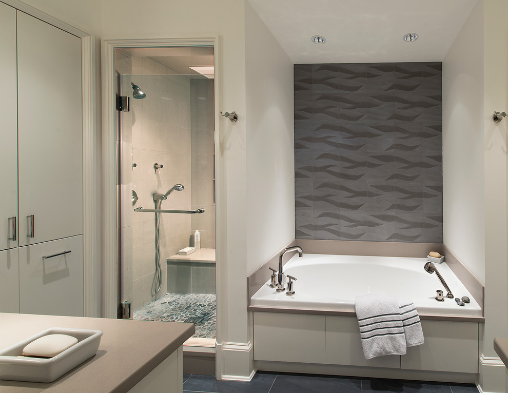 Design ideas for a mid-sized contemporary master bathroom in DC Metro with flat-panel cabinets, grey cabinets, an alcove tub, an alcove shower, a one-piece toilet, beige tile, pebble tile, white walls, ceramic floors, an undermount sink and engineered quartz benchtops.