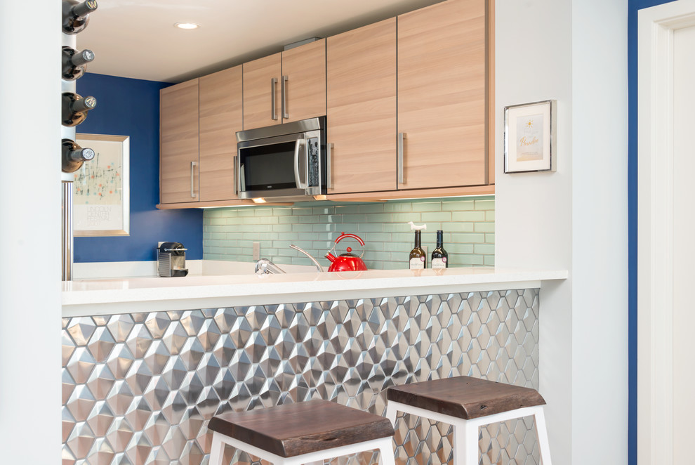 Small transitional u-shaped open plan kitchen in San Francisco with flat-panel cabinets, light wood cabinets, quartzite benchtops, blue splashback, glass tile splashback, stainless steel appliances and no island.