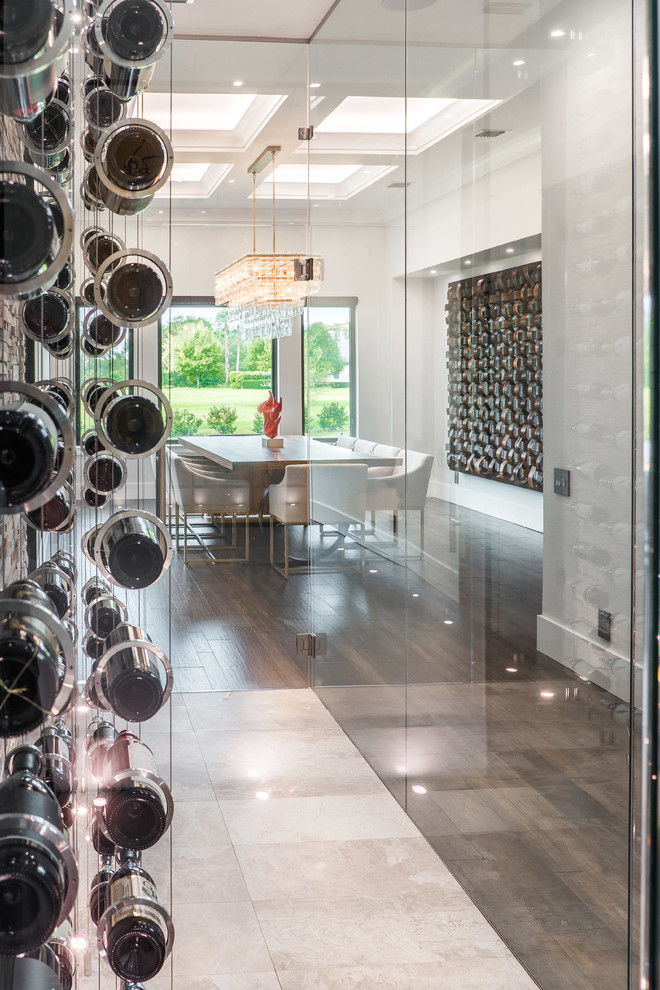 Small contemporary wine cellar in Tampa with beige floor and display racks.