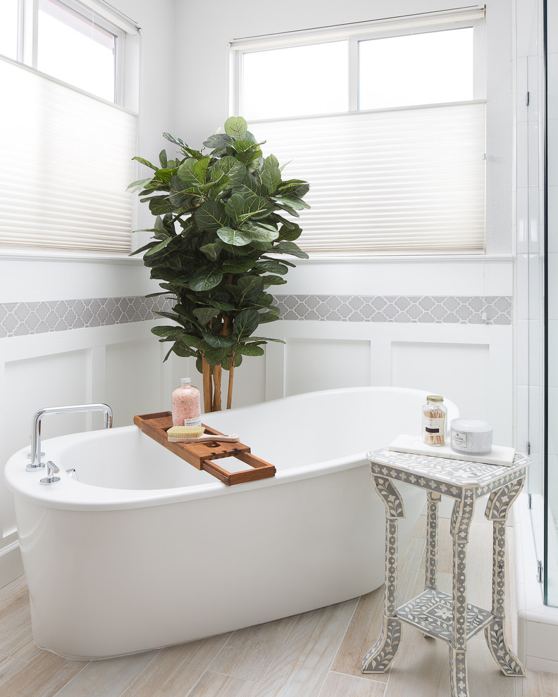 This is an example of a transitional bathroom in Sacramento with a freestanding tub.