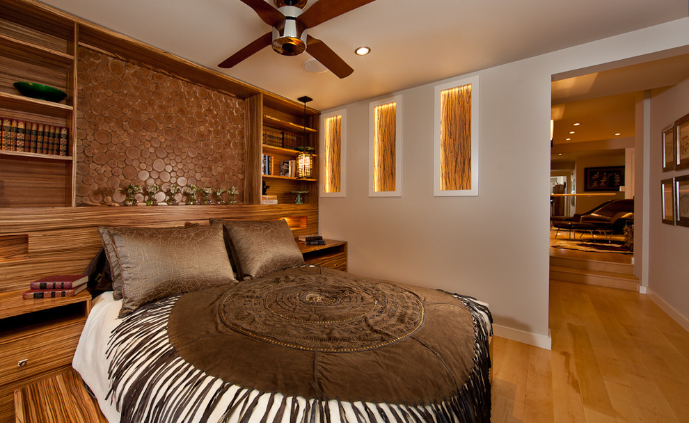 Photo of a contemporary bedroom in Albuquerque with beige walls and medium hardwood floors.