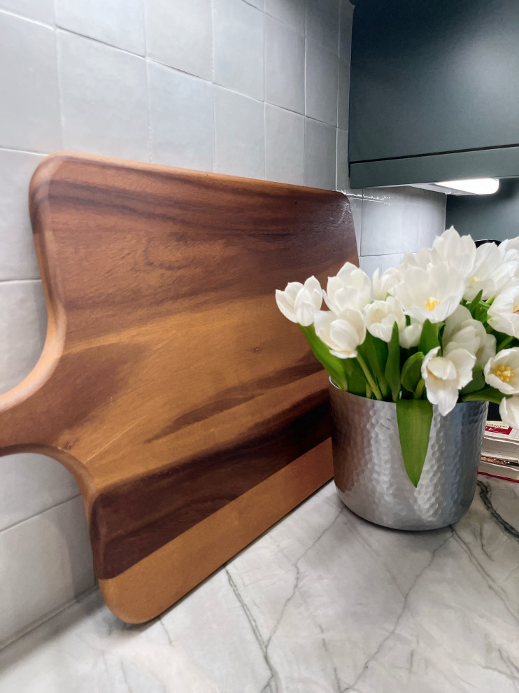 Inspiration for a mid-sized transitional l-shaped marble floor and beige floor enclosed kitchen remodel with an undermount sink, shaker cabinets, green cabinets, quartzite countertops, white backsplash, ceramic backsplash, stainless steel appliances, a peninsula and gray countertops