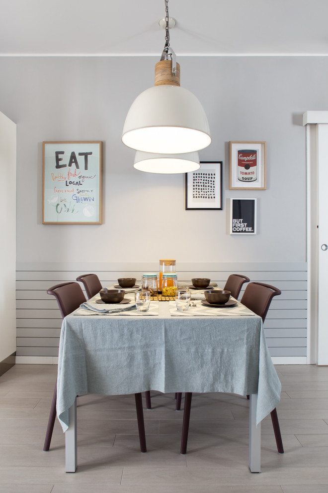 Photo of a mid-sized contemporary dining room in Milan with grey walls and porcelain floors.