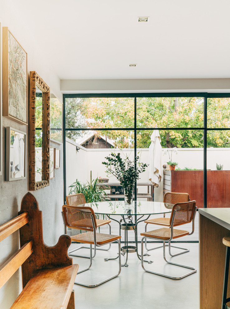 This is an example of a contemporary dining room in Sydney with white walls and no fireplace.