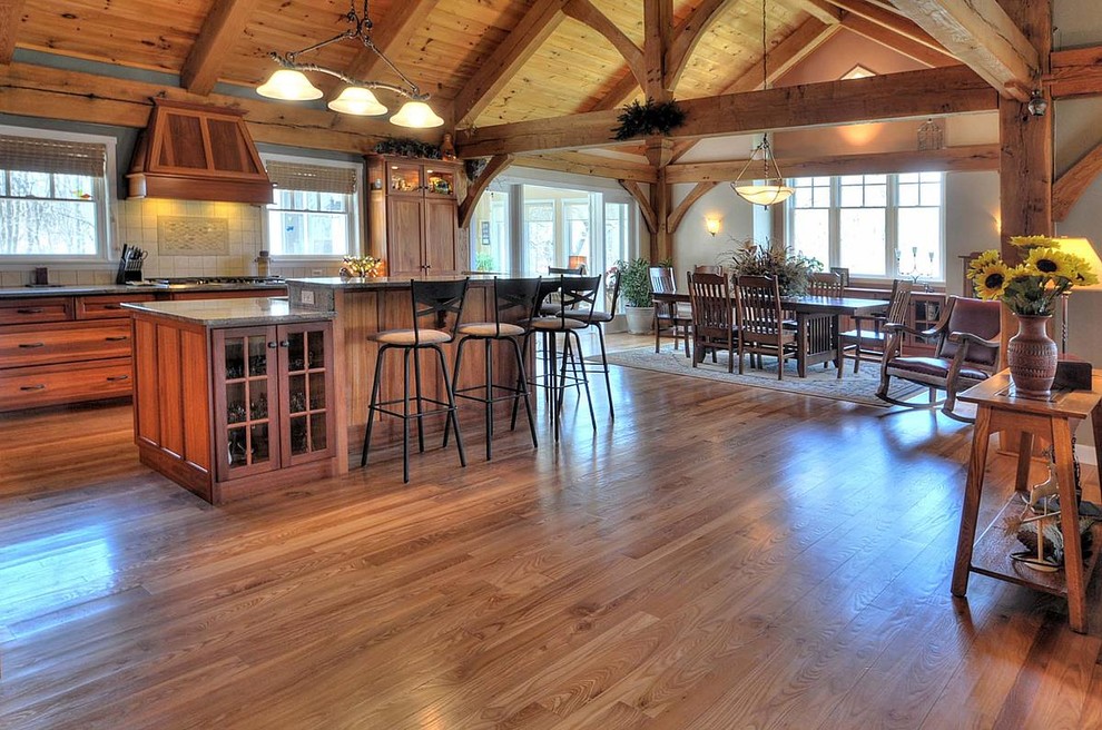 Eat-in kitchen - mid-sized rustic galley medium tone wood floor eat-in kitchen idea in Milwaukee with an undermount sink, recessed-panel cabinets, medium tone wood cabinets, white backsplash, ceramic backsplash and an island