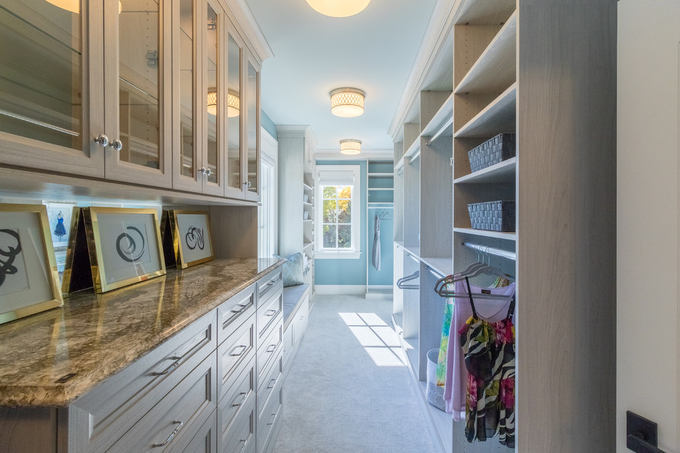Inspiration for a large traditional women's walk-in wardrobe in Minneapolis with recessed-panel cabinets, light wood cabinets, carpet and grey floor.