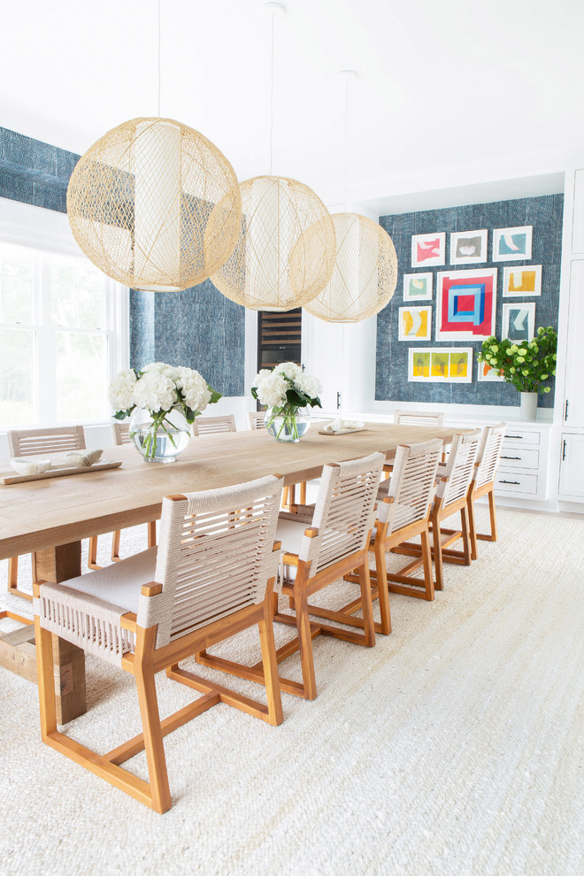 Large beach style separate dining room in New York with blue walls, light hardwood floors, beige floor and no fireplace.