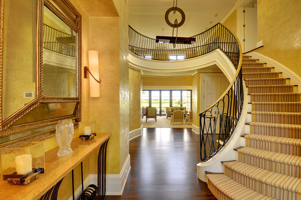 Photo of a mediterranean wood curved staircase in New York with painted wood risers.