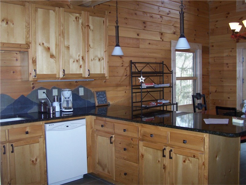 Mid-sized mountain style u-shaped porcelain tile open concept kitchen photo in Chicago with an undermount sink, shaker cabinets, light wood cabinets, granite countertops, blue backsplash, porcelain backsplash, white appliances and a peninsula