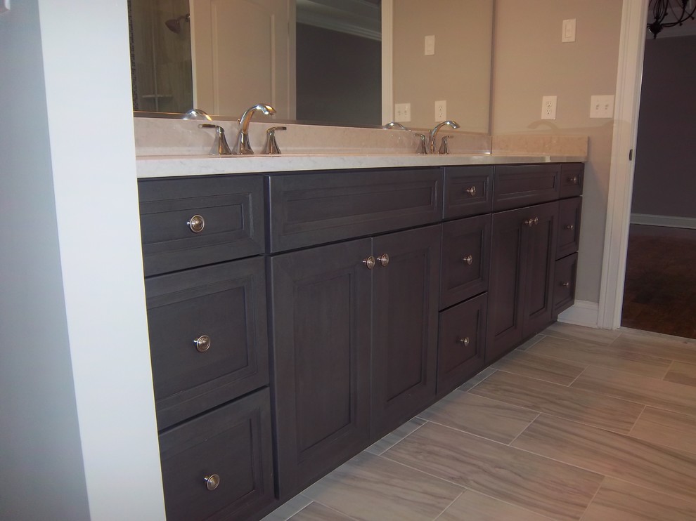 Example of a mid-sized transitional master porcelain tile porcelain tile and beige floor alcove bathtub design with recessed-panel cabinets, dark wood cabinets, beige walls, an undermount sink, granite countertops and beige countertops
