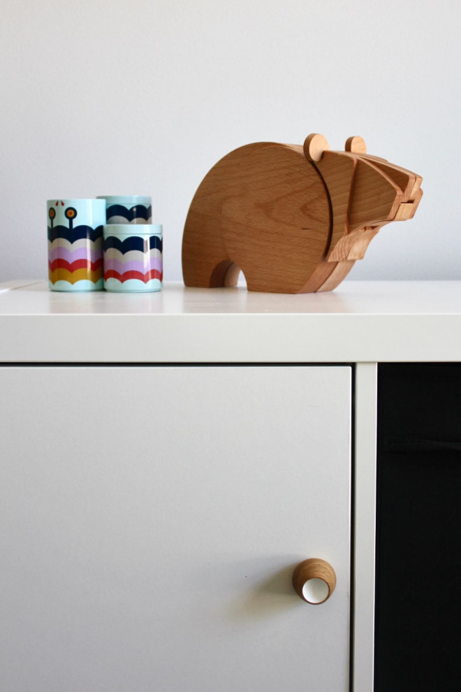 Small scandinavian gender-neutral kids' room in Sydney with white walls, carpet, grey floor and vaulted.