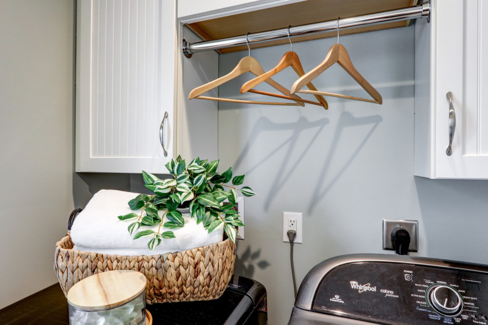 Design ideas for a small traditional single-wall dedicated laundry room in Other with louvered cabinets, white cabinets, grey walls, ceramic floors, a side-by-side washer and dryer and beige floor.