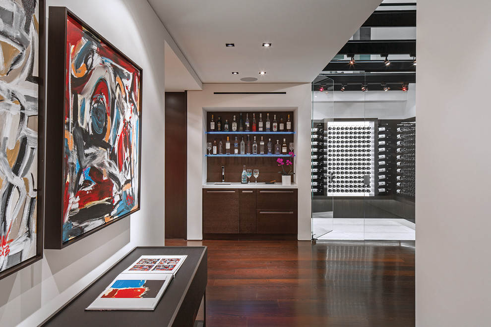 This is an example of a contemporary wine cellar in Los Angeles with dark hardwood floors and storage racks.