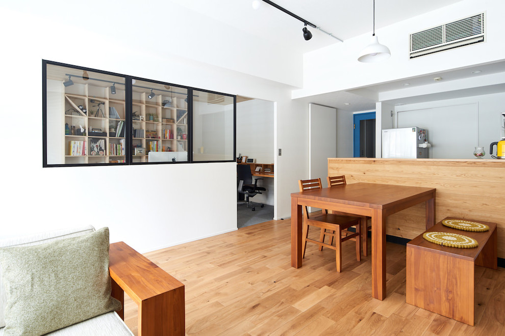Photo of an industrial open plan dining in Other with brown walls, medium hardwood floors and brown floor.