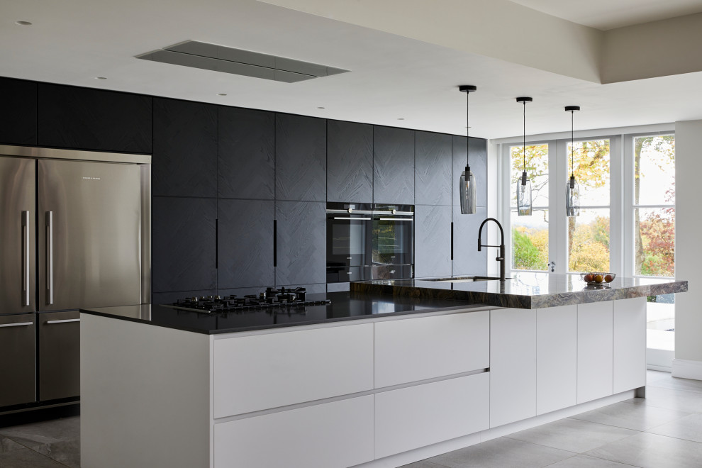 Photo of an expansive contemporary single-wall kitchen/diner in Kent with flat-panel cabinets, dark wood cabinets, multi-coloured splashback, stone slab splashback, stainless steel appliances, porcelain flooring, an island, grey floors and multicoloured worktops.