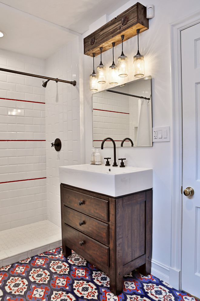 Inspiration for a mid-sized mediterranean 3/4 bathroom in Miami with flat-panel cabinets, dark wood cabinets, an alcove shower, red tile, white tile, subway tile, white walls, ceramic floors, a vessel sink, multi-coloured floor and a shower curtain.