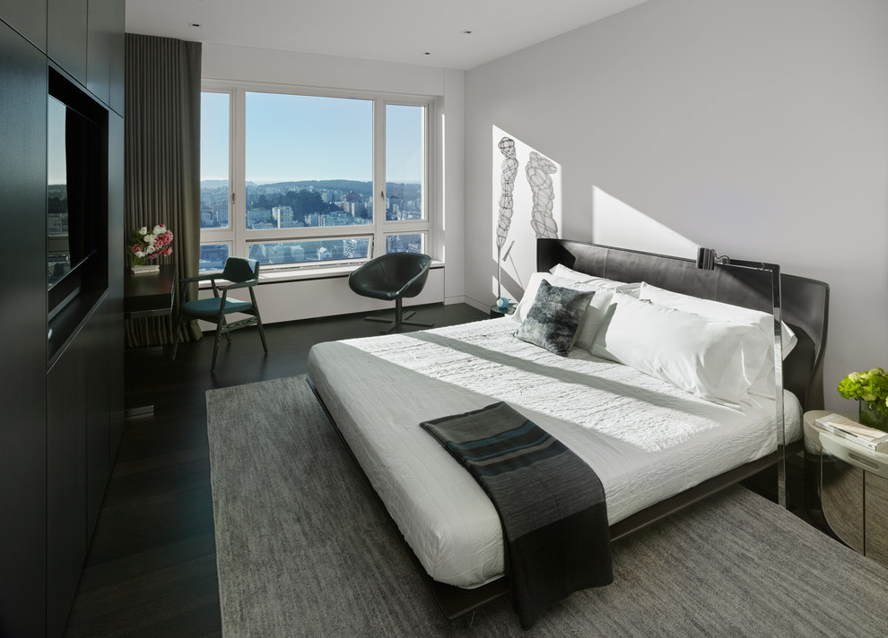 This is an example of a mid-sized contemporary master bedroom in San Francisco with white walls and dark hardwood floors.