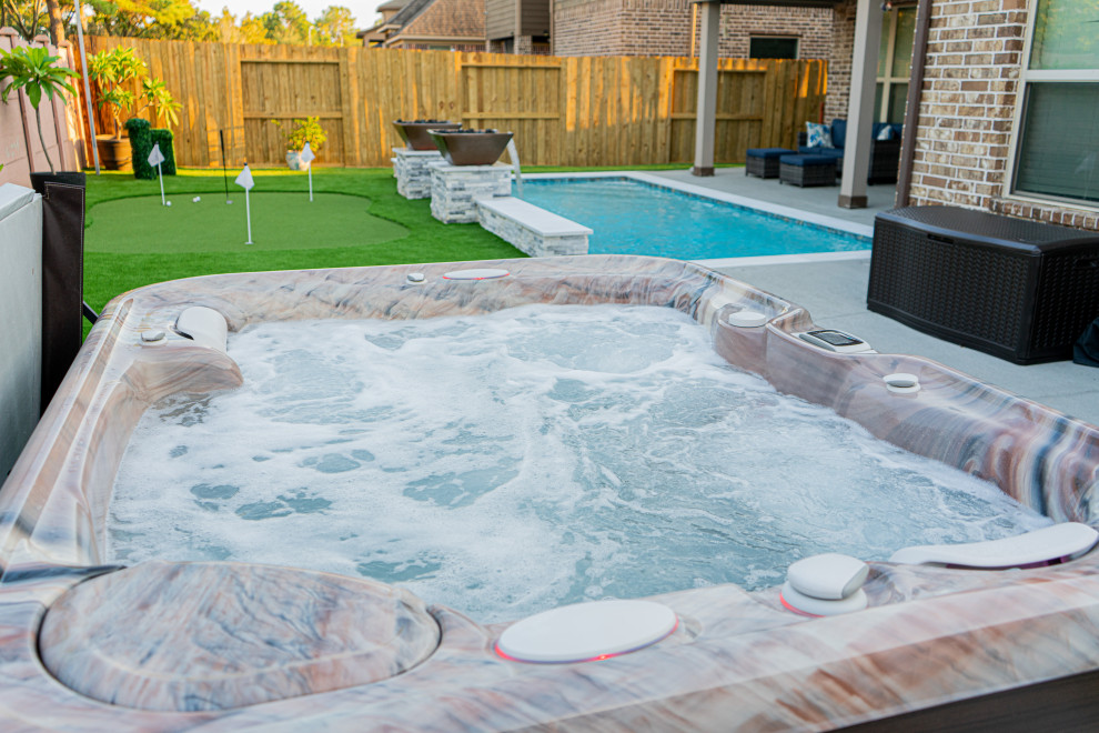 На фото: маленький прямоугольный бассейн на заднем дворе в классическом стиле с джакузи и покрытием из каменной брусчатки для на участке и в саду