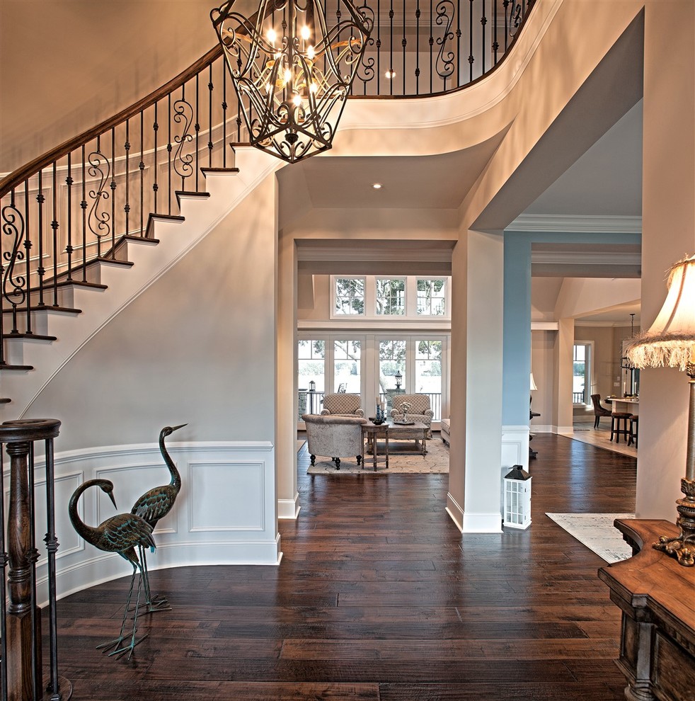 Large traditional wood curved staircase in Atlanta with painted wood risers.