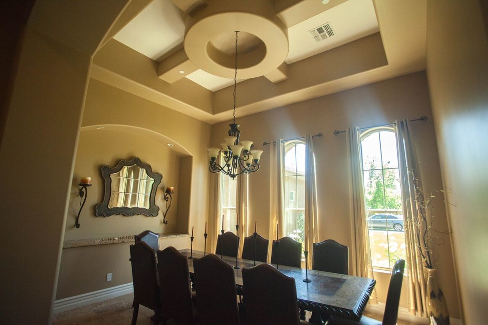 Large transitional travertine floor and brown floor enclosed dining room photo in Phoenix with brown walls and no fireplace
