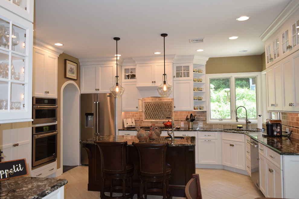 Inspiration for a transitional ceramic tile and gray floor kitchen remodel with an undermount sink, recessed-panel cabinets, white cabinets, quartz countertops, beige backsplash, subway tile backsplash, stainless steel appliances and an island