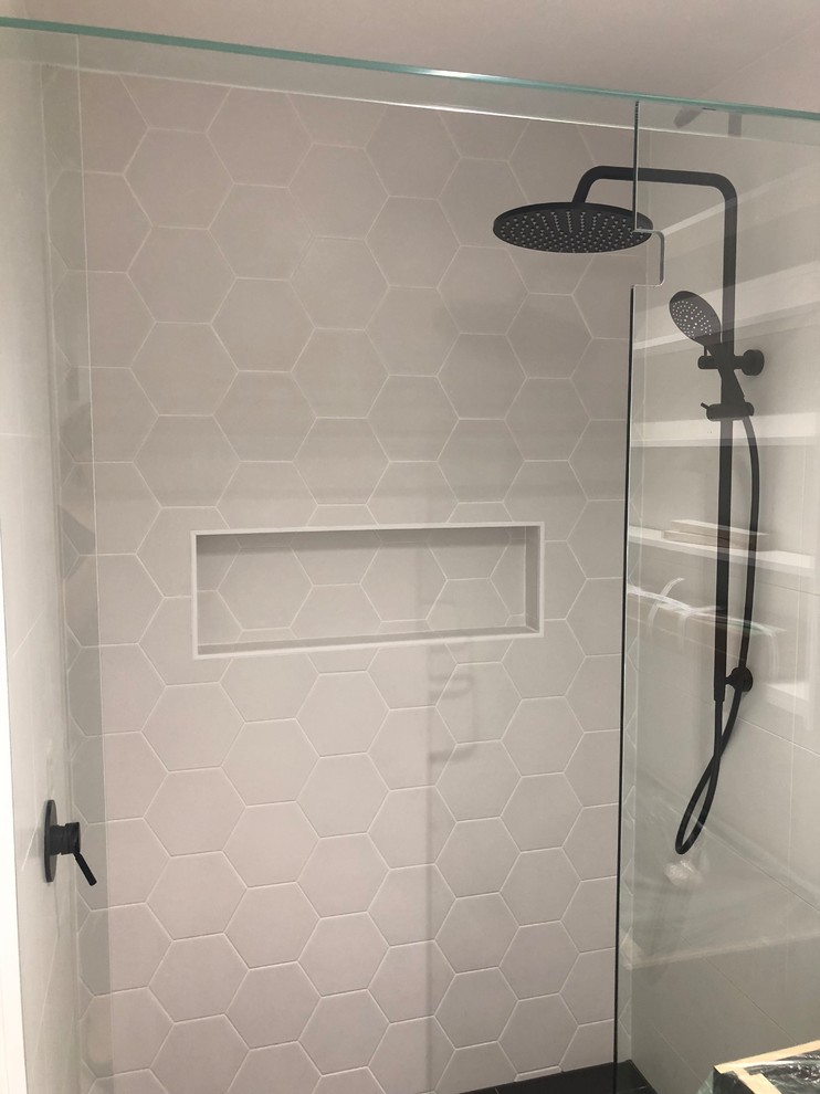 Design ideas for a mid-sized contemporary kids bathroom in Brisbane with a double shower, white tile, porcelain tile, porcelain floors, black floor and an open shower.